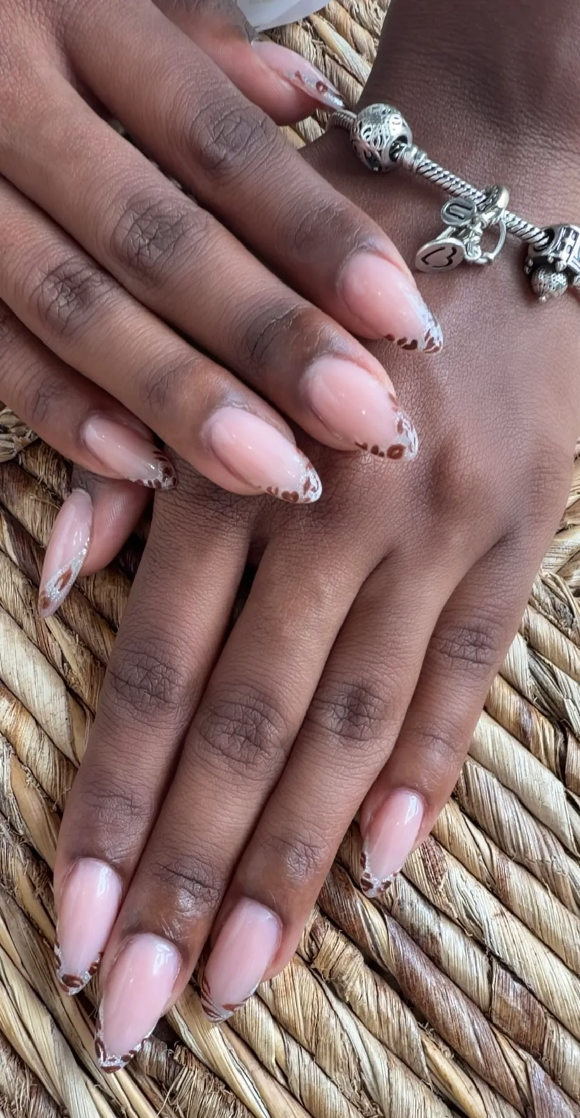 Almond nails with delicate leopard-print French tips.